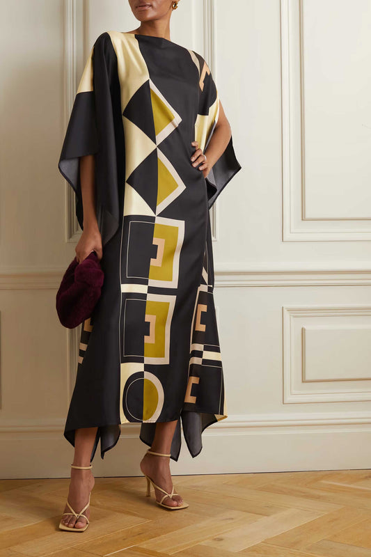 Model wearing black and cream geometric patterned kaftan with waist tie