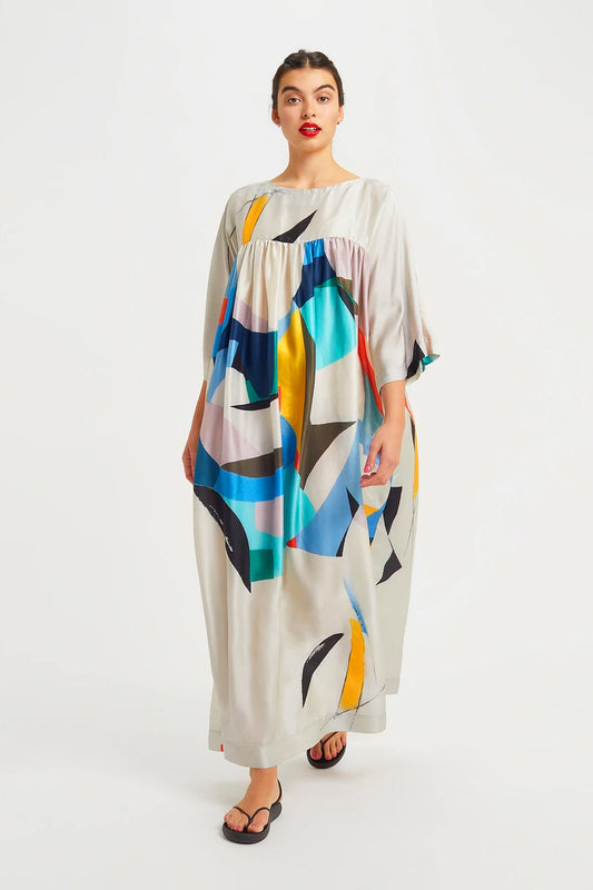 Modern art inspired Maxi featuring an abstract pattern with bold shapes in blue, black, yellow, and red, on an off-white background.