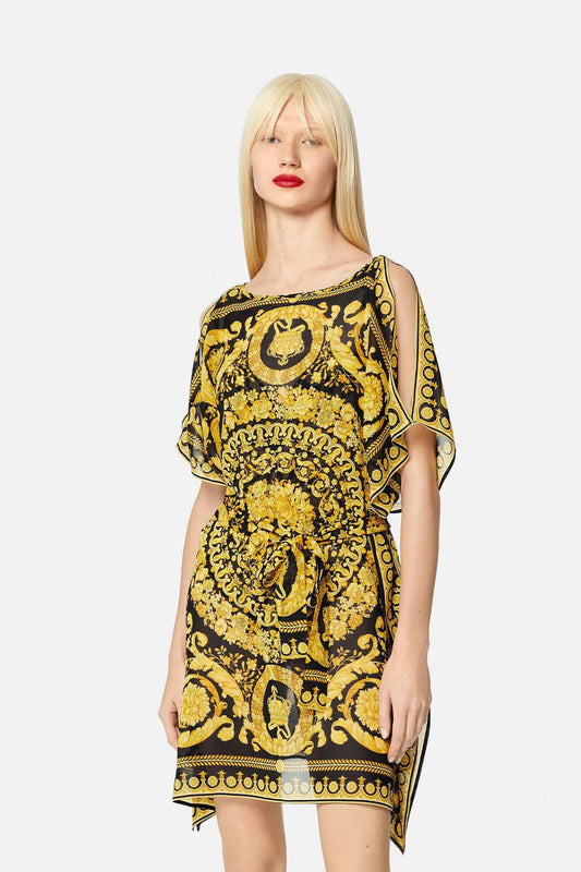 A model in a black and gold baroque patterned kaftan