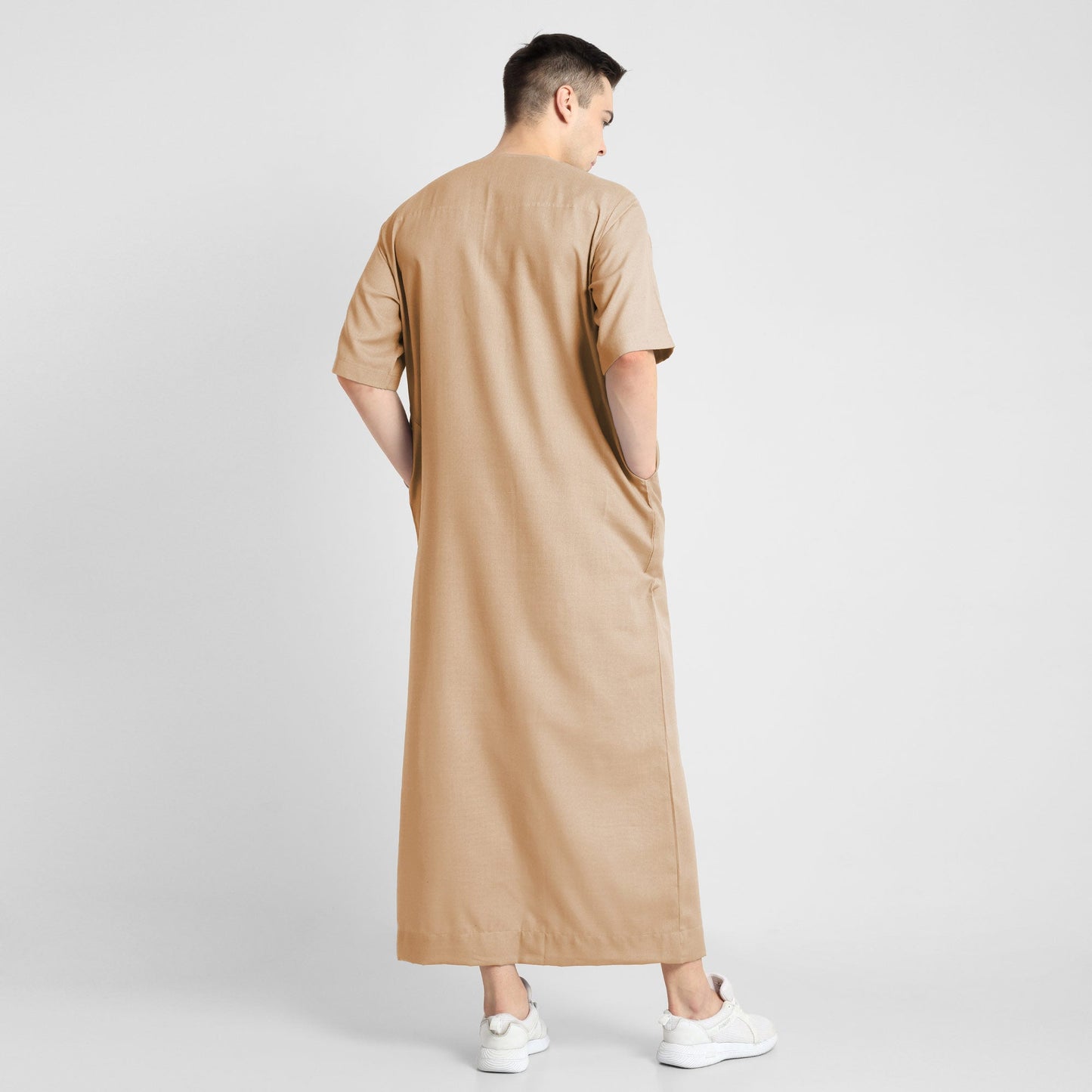 Man wearing a Beige, ankle-length thobe with a relaxed fit, embodying a fusion of traditional charm and modern simplicity