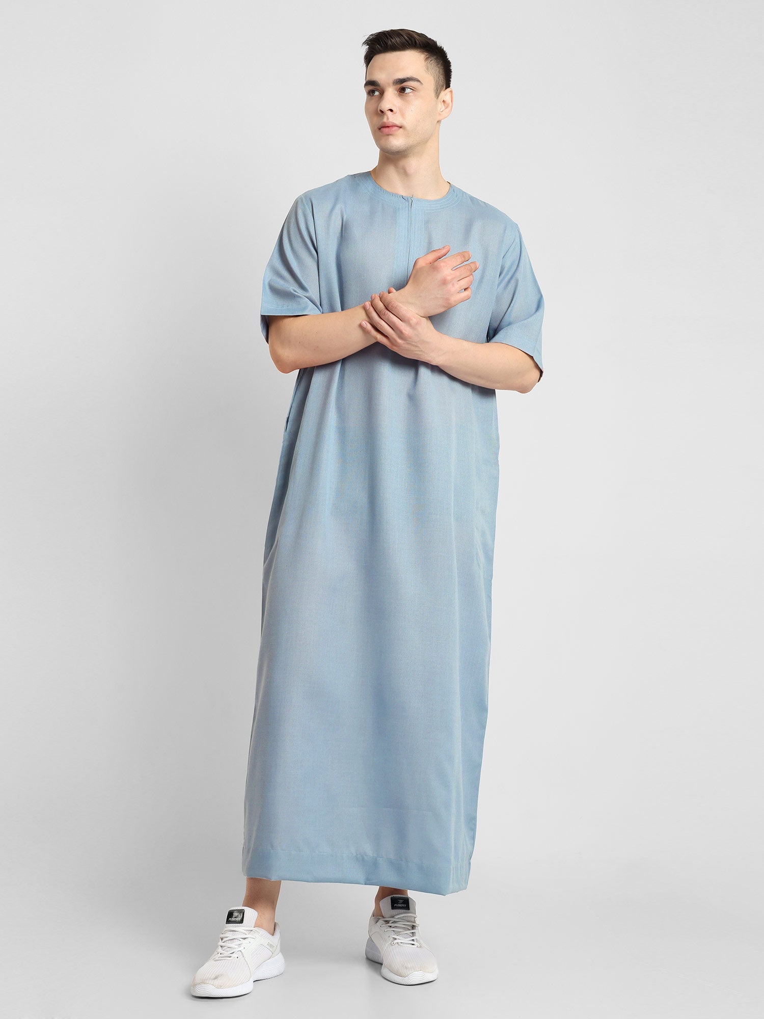 Man wearing a Blue, ankle-length thobe with a relaxed fit, embodying a fusion of traditional charm and modern simplicity