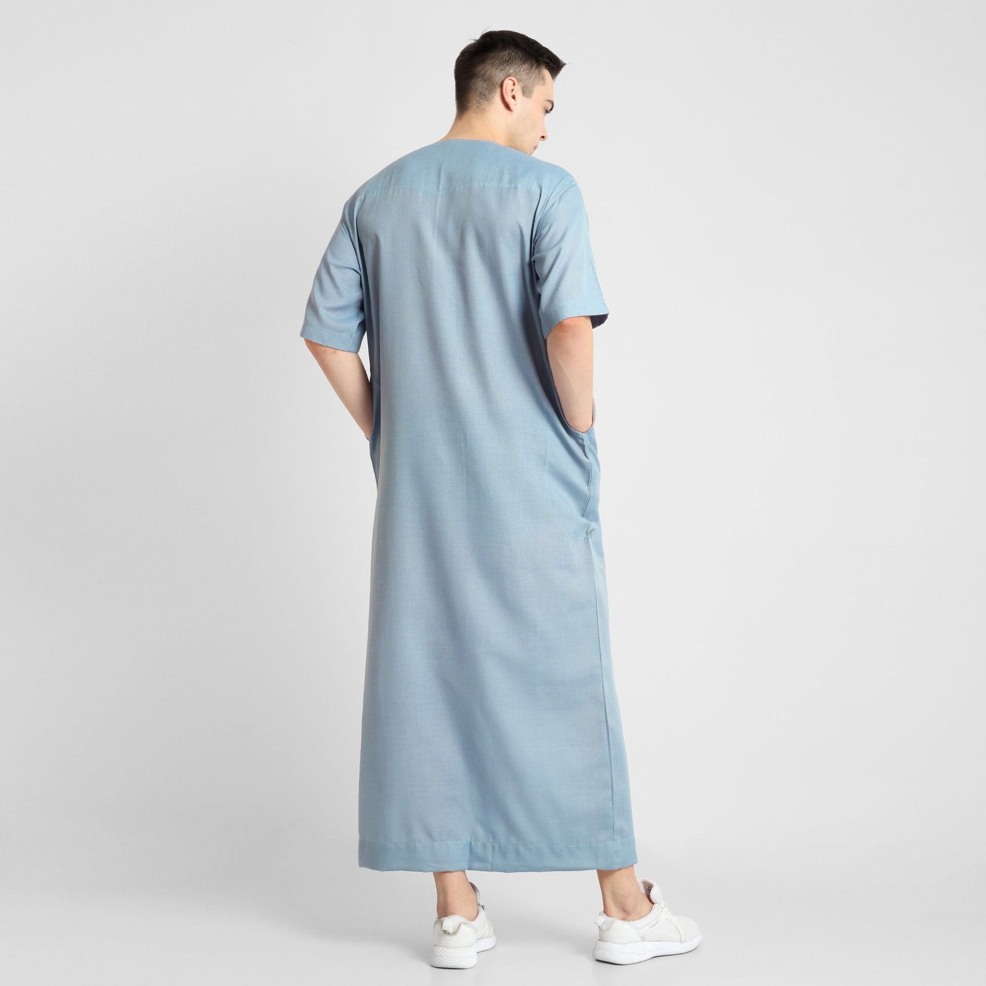 Man wearing a Blue, ankle-length thobe with a relaxed fit, embodying a fusion of traditional charm and modern simplicity