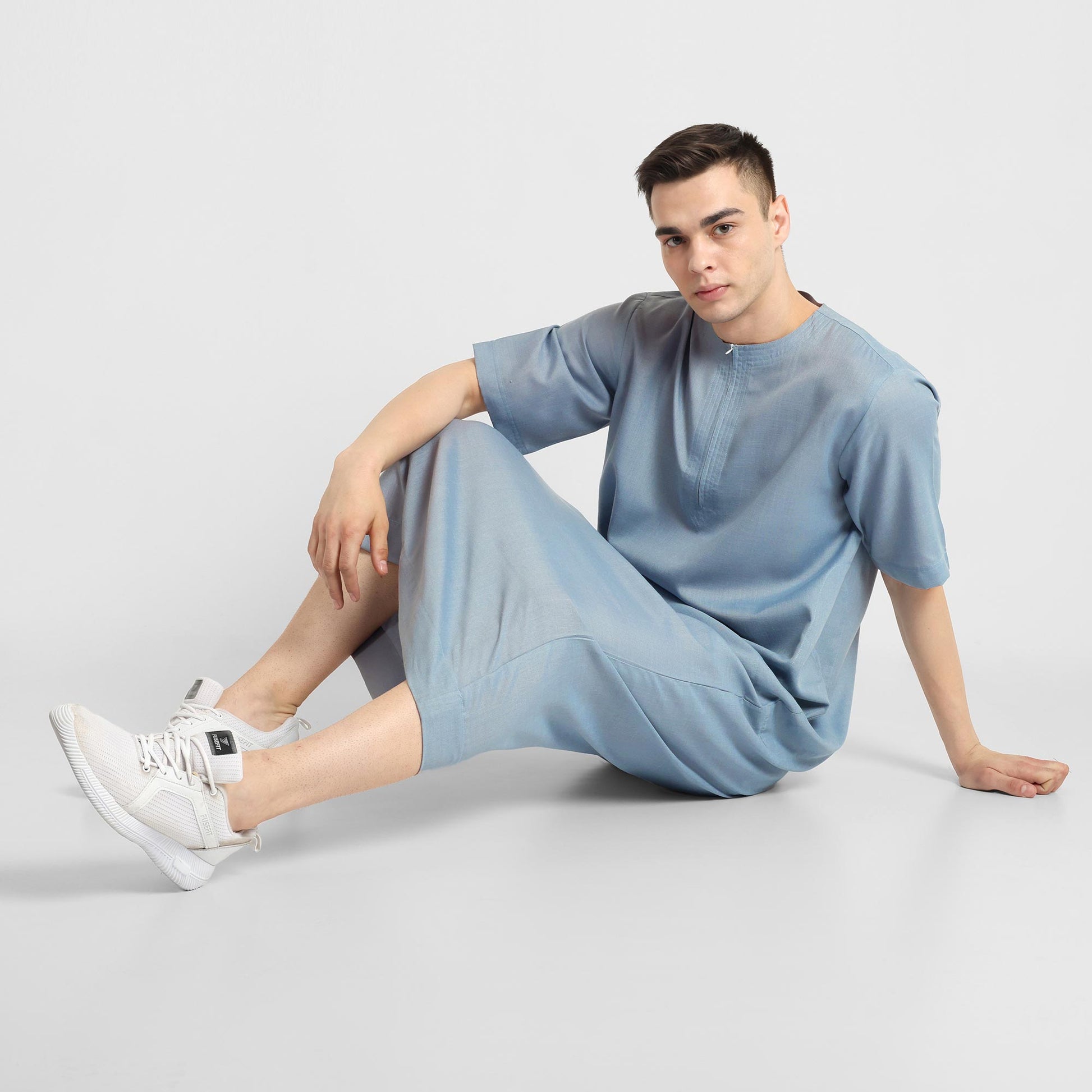 Man wearing a Blue, ankle-length thobe with a relaxed fit, embodying a fusion of traditional charm and modern simplicity