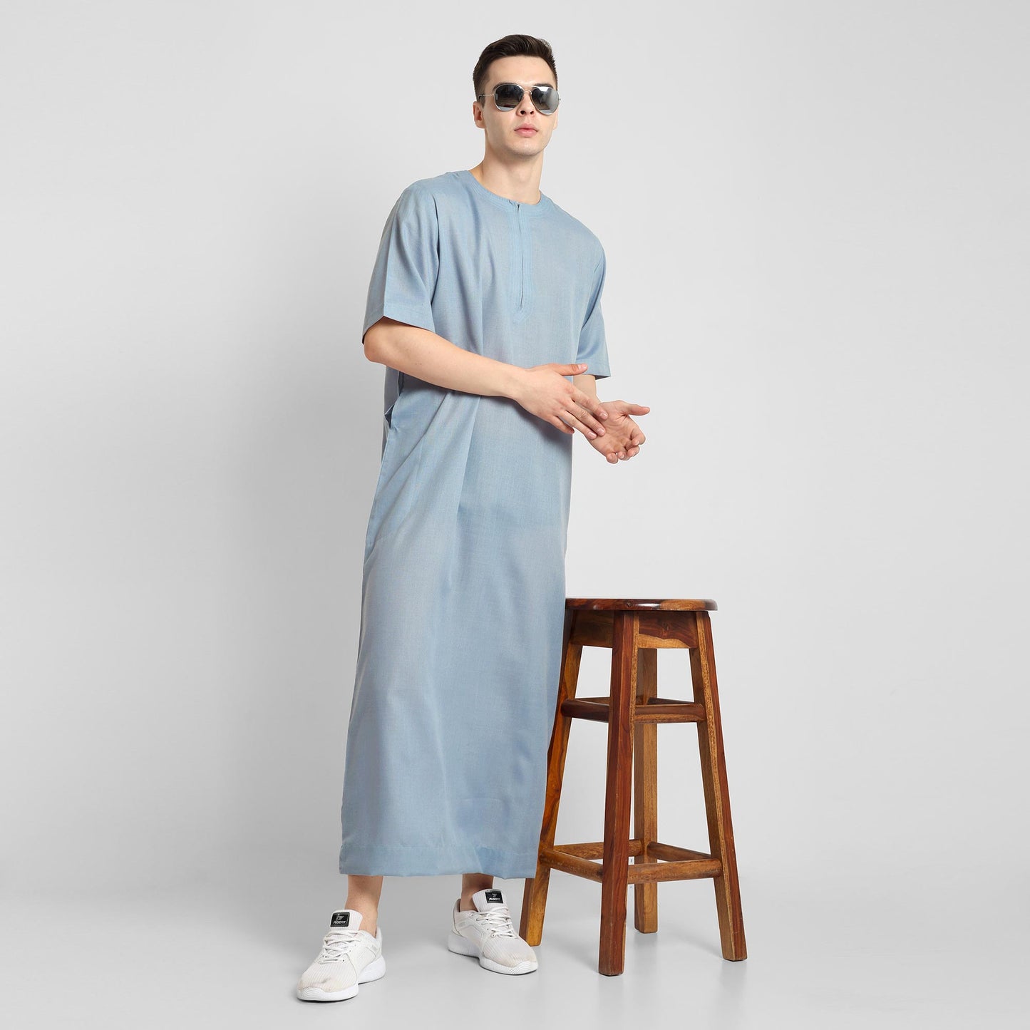 Man wearing a Blue, ankle-length thobe with a relaxed fit, embodying a fusion of traditional charm and modern simplicity