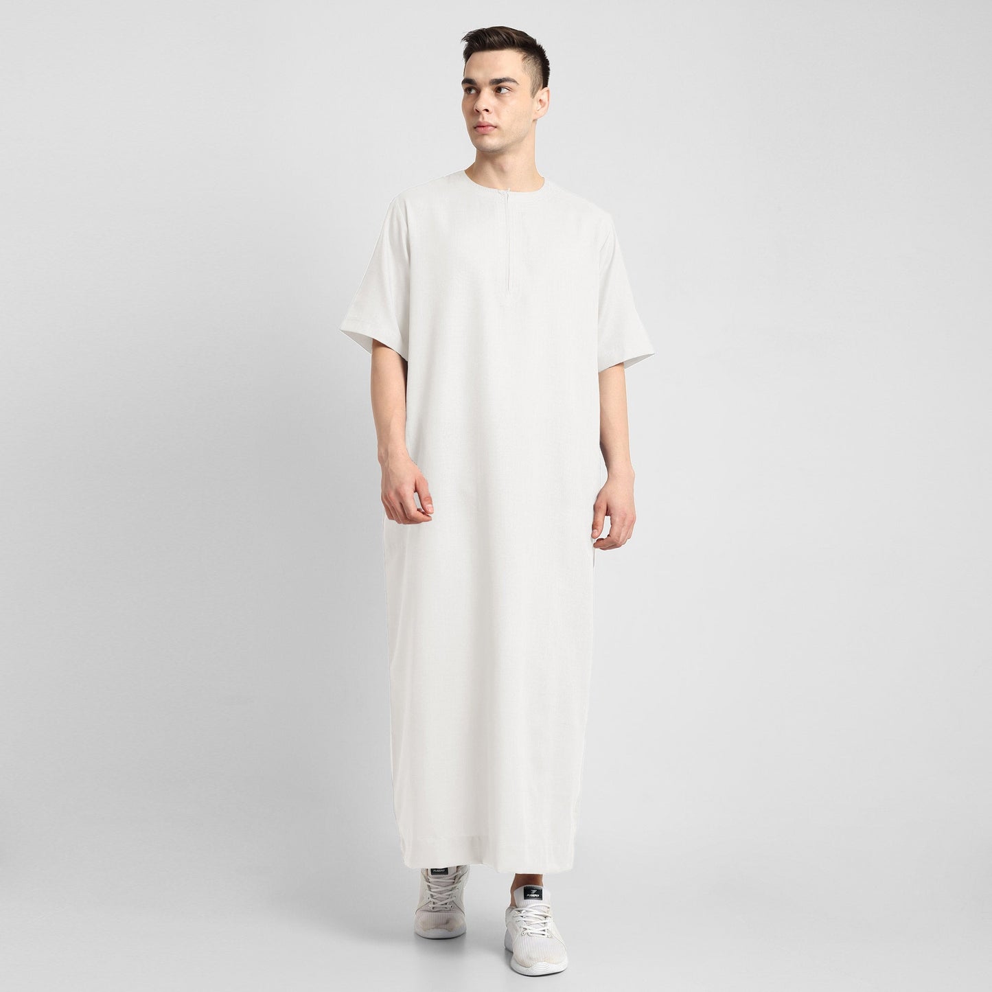 Man wearing a White, ankle-length thobe with a relaxed fit, embodying a fusion of traditional charm and modern simplicity