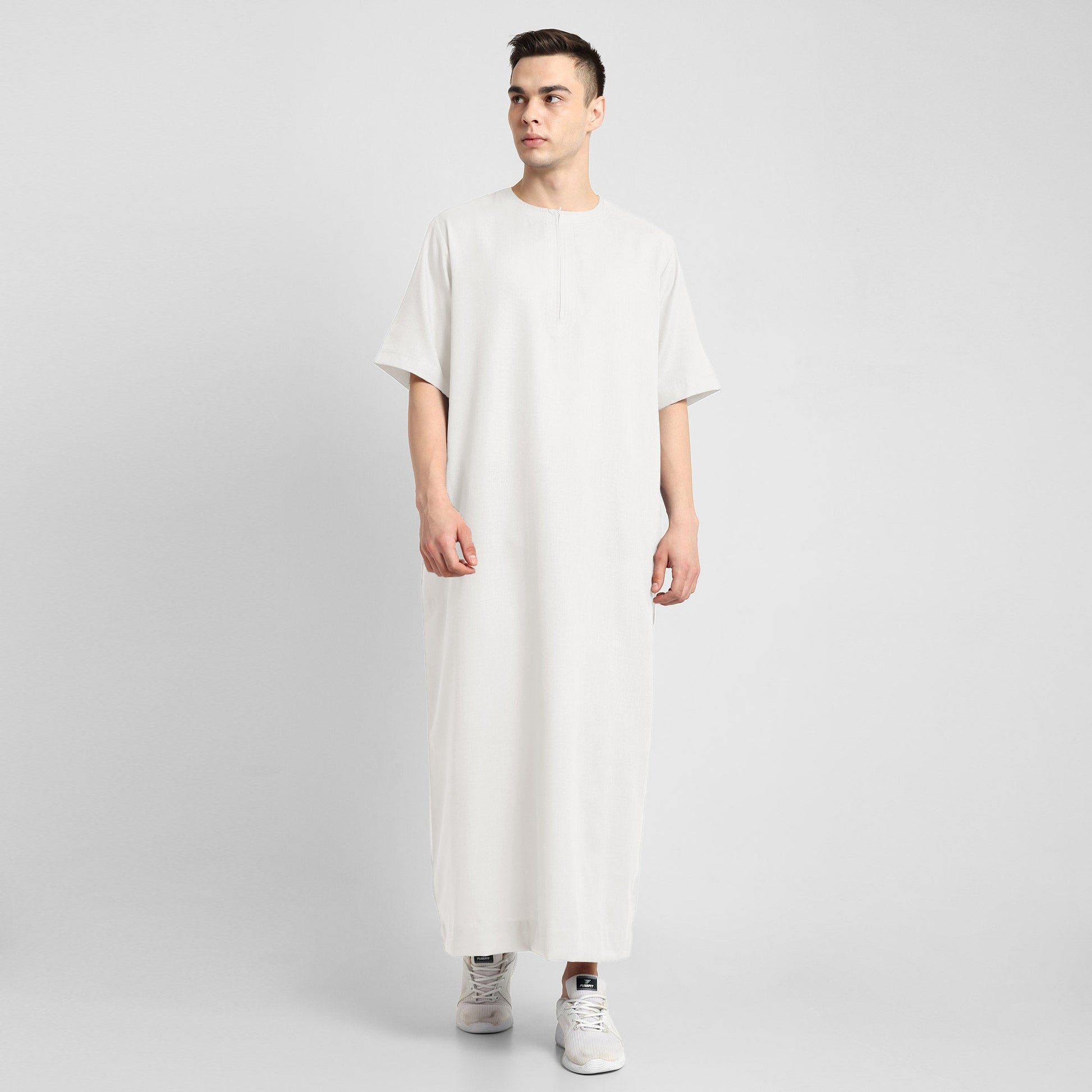 Man wearing a White, ankle-length thobe with a relaxed fit, embodying a fusion of traditional charm and modern simplicity