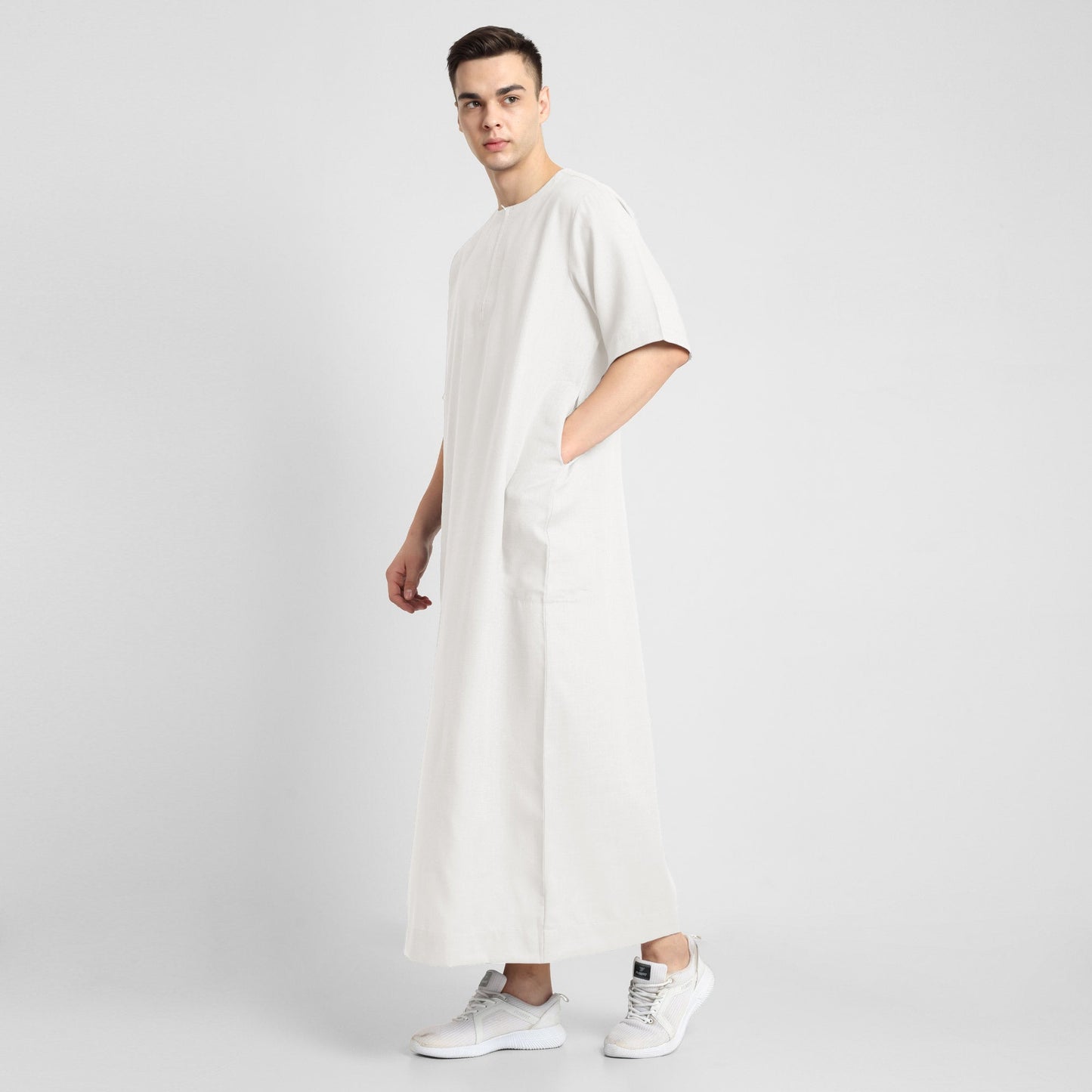 Man wearing a White, ankle-length thobe with a relaxed fit, embodying a fusion of traditional charm and modern simplicity