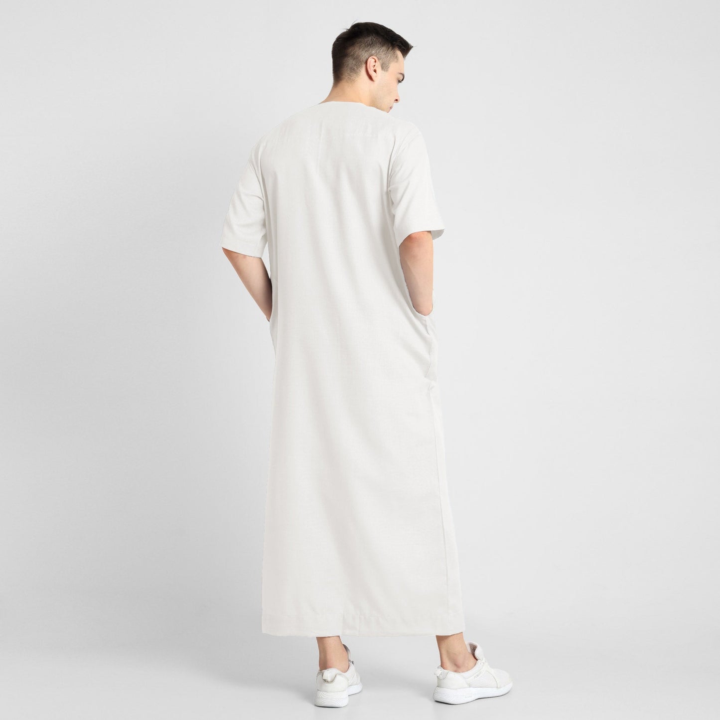 Man wearing a White, ankle-length thobe with a relaxed fit, embodying a fusion of traditional charm and modern simplicity