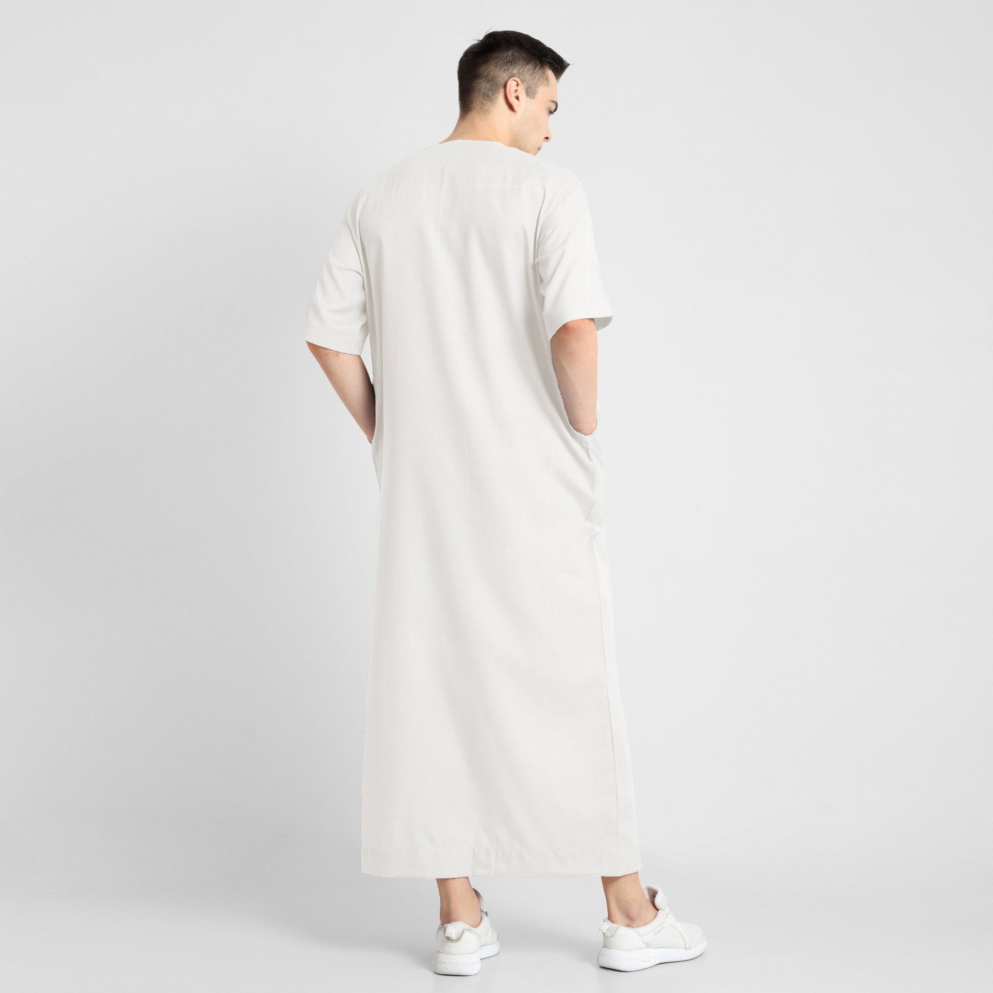 Man wearing a White, ankle-length thobe with a relaxed fit, embodying a fusion of traditional charm and modern simplicity