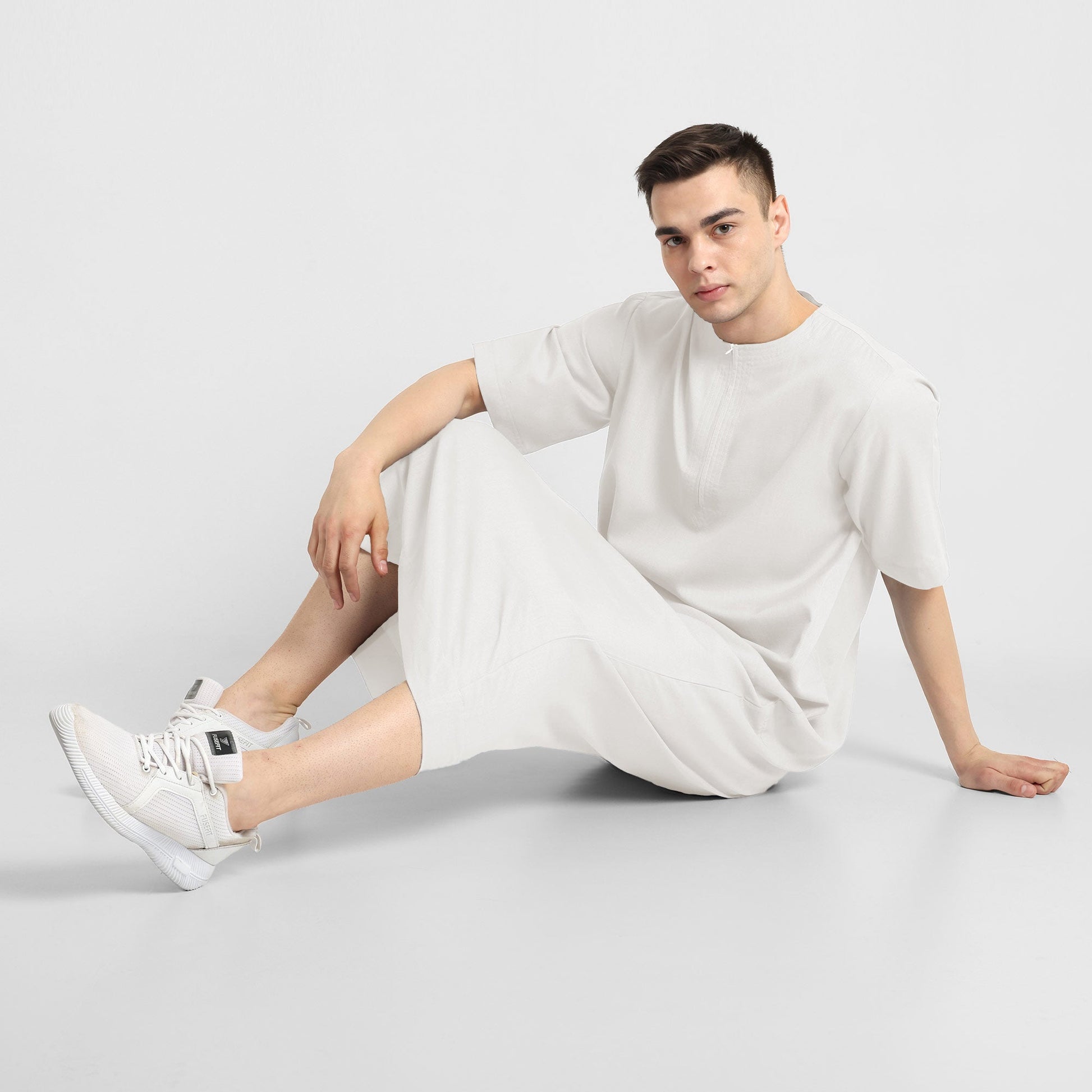 Man wearing a White, ankle-length thobe with a relaxed fit, embodying a fusion of traditional charm and modern simplicity