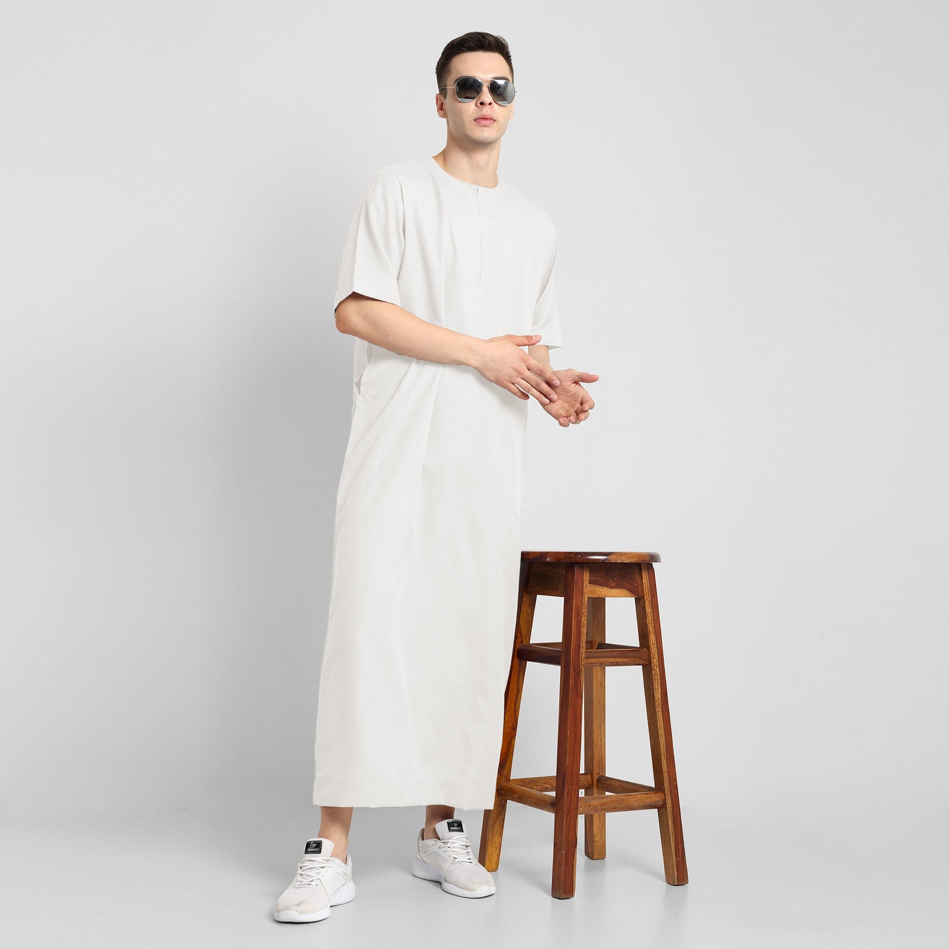 Man wearing a White, ankle-length thobe with a relaxed fit, embodying a fusion of traditional charm and modern simplicity
