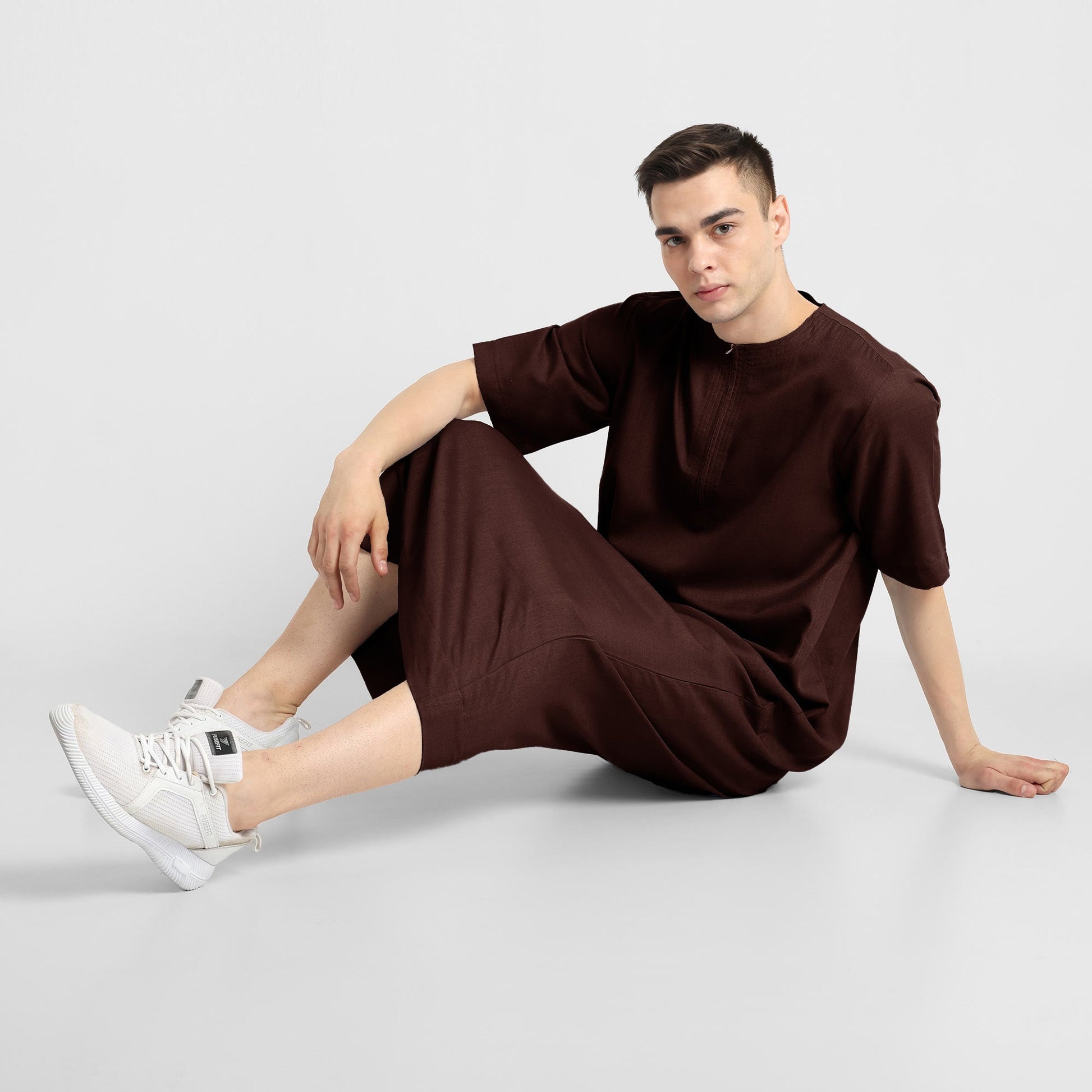 Man wearing a brown, ankle-length thobe with a relaxed fit, embodying a fusion of traditional charm and modern simplicity