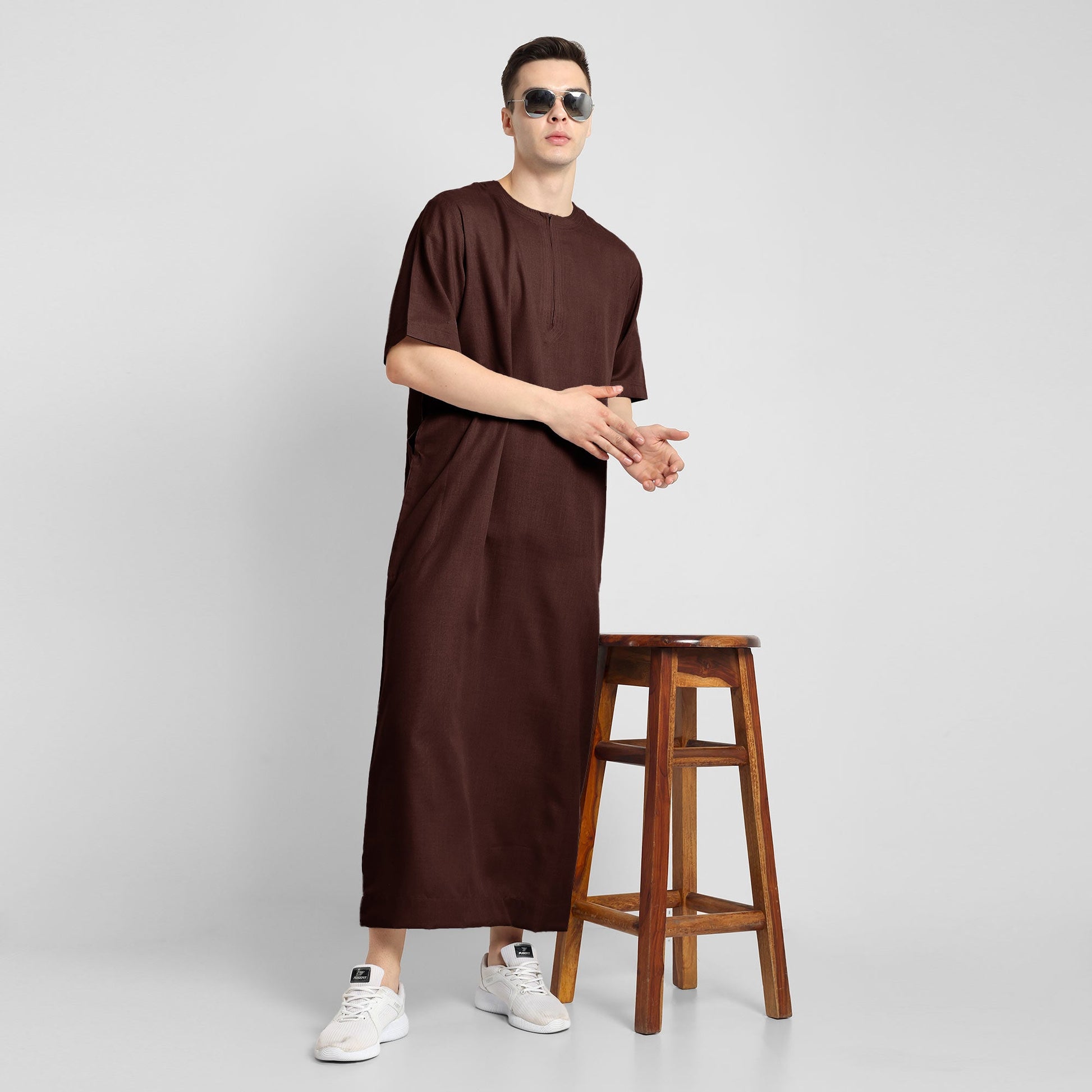 Man wearing a brown, ankle-length thobe with a relaxed fit, embodying a fusion of traditional charm and modern simplicity
