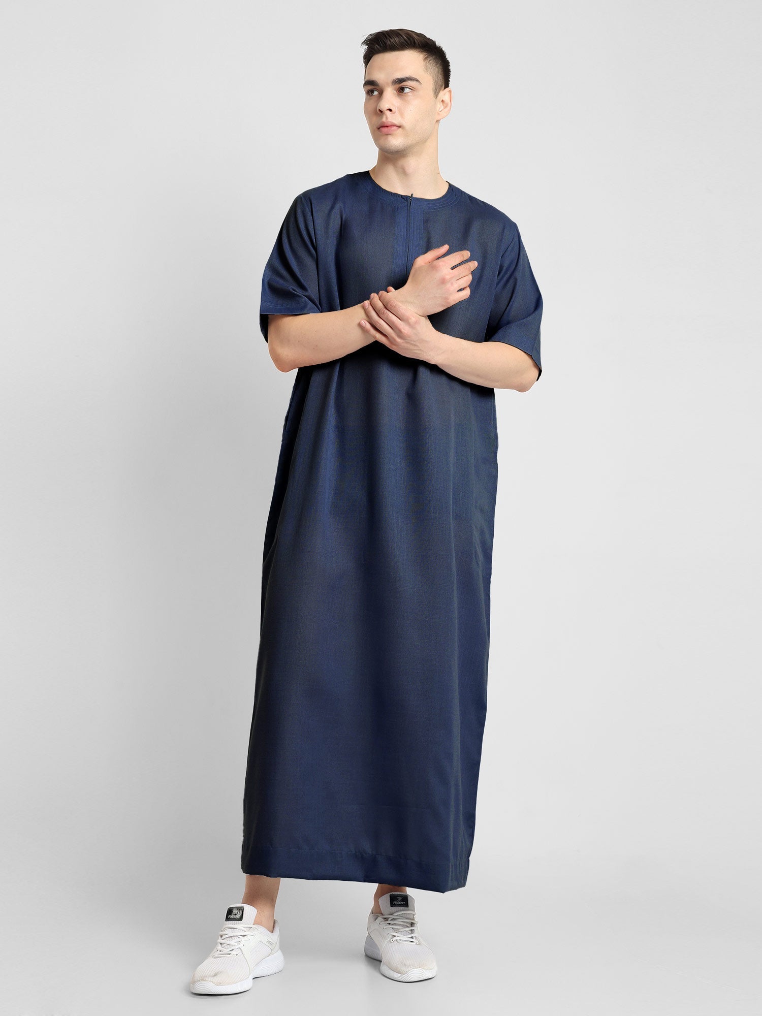 Man wearing a Navy Blue, ankle-length thobe with a relaxed fit, embodying a fusion of traditional charm and modern simplicity