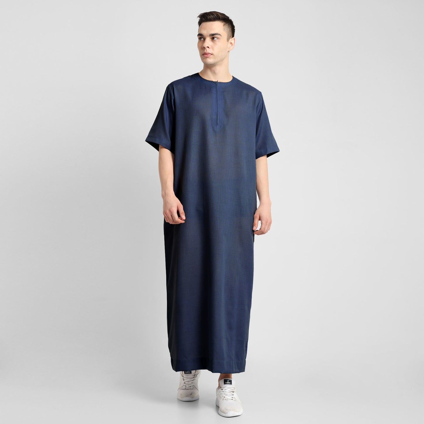 Man wearing a Navy Blue, ankle-length thobe with a relaxed fit, embodying a fusion of traditional charm and modern simplicity