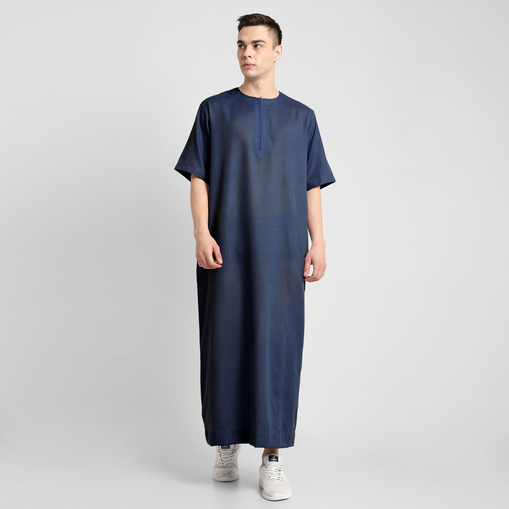 Man wearing a Navy Blue, ankle-length thobe with a relaxed fit, embodying a fusion of traditional charm and modern simplicity