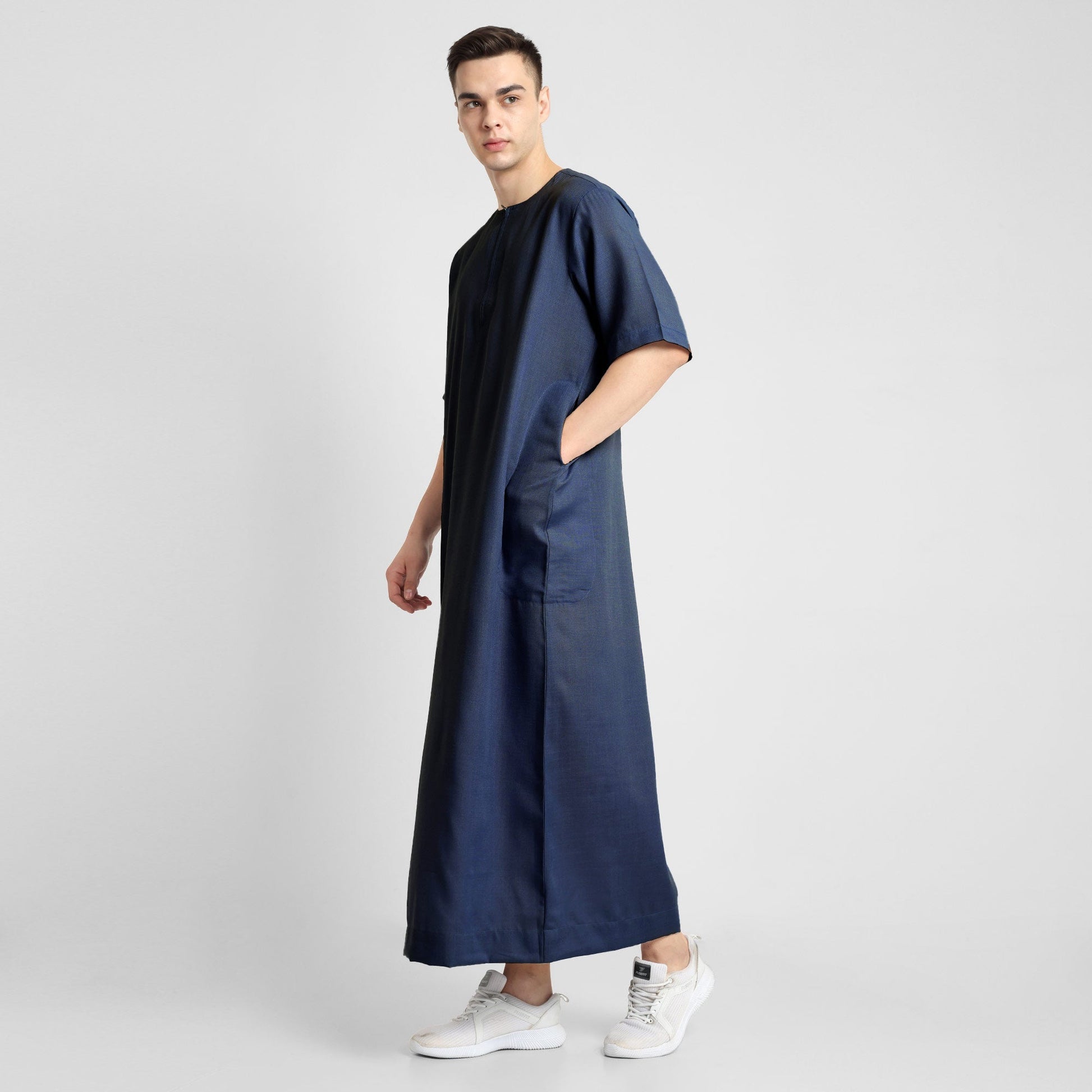 Man wearing a Navy Blue, ankle-length thobe with a relaxed fit, embodying a fusion of traditional charm and modern simplicity