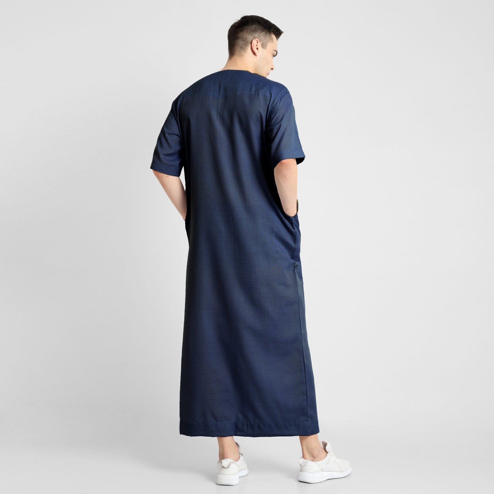 Man wearing a Navy Blue, ankle-length thobe with a relaxed fit, embodying a fusion of traditional charm and modern simplicity