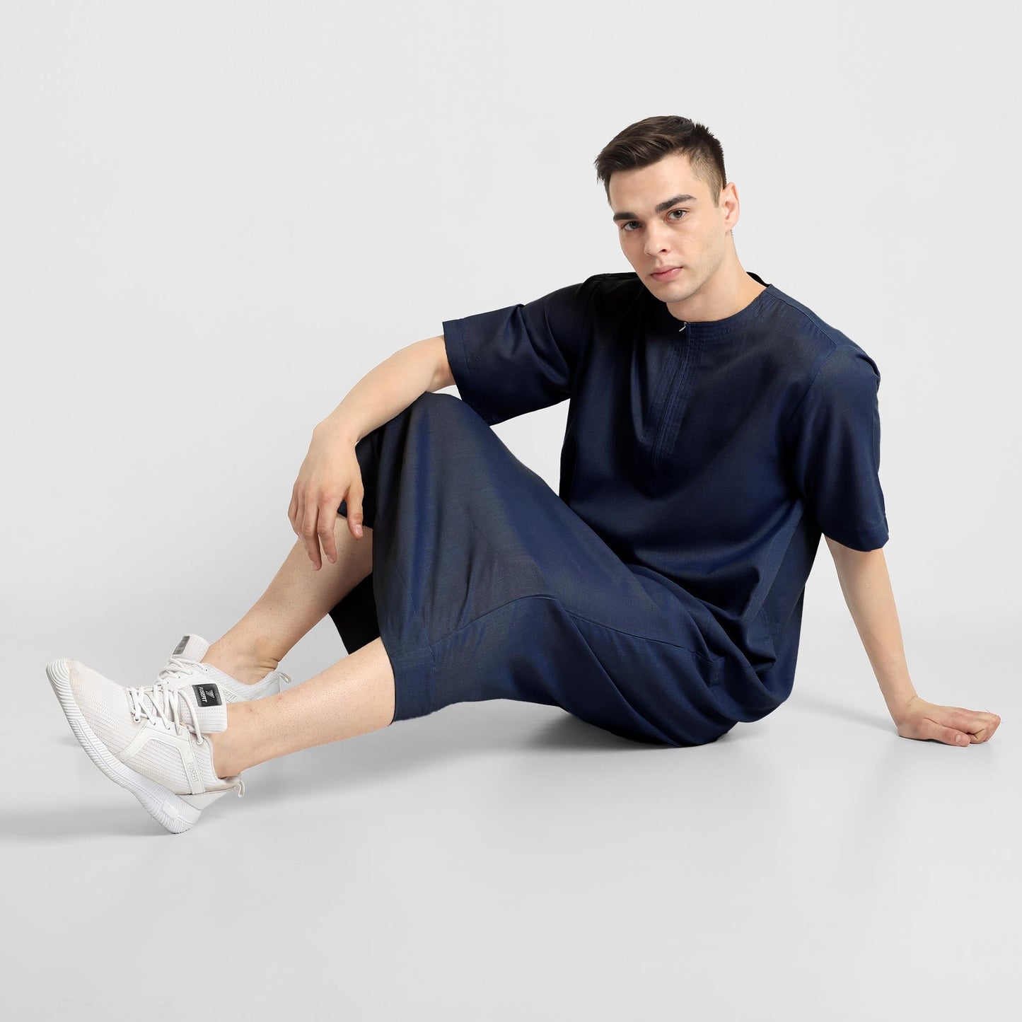 Man wearing a Navy Blue, ankle-length thobe with a relaxed fit, embodying a fusion of traditional charm and modern simplicity