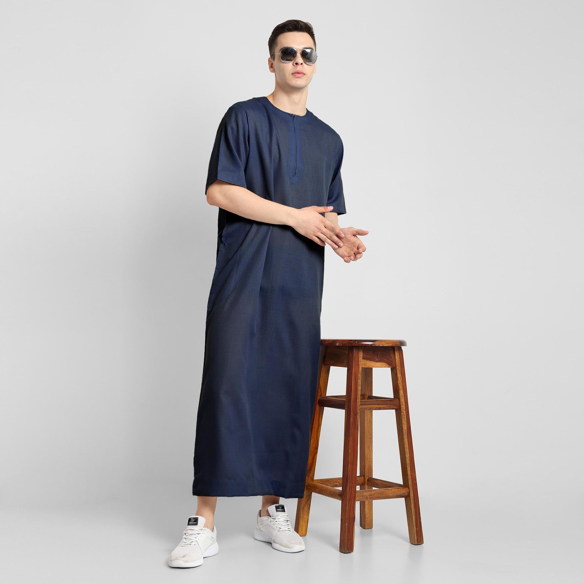 Man wearing a Navy Blue, ankle-length thobe with a relaxed fit, embodying a fusion of traditional charm and modern simplicity