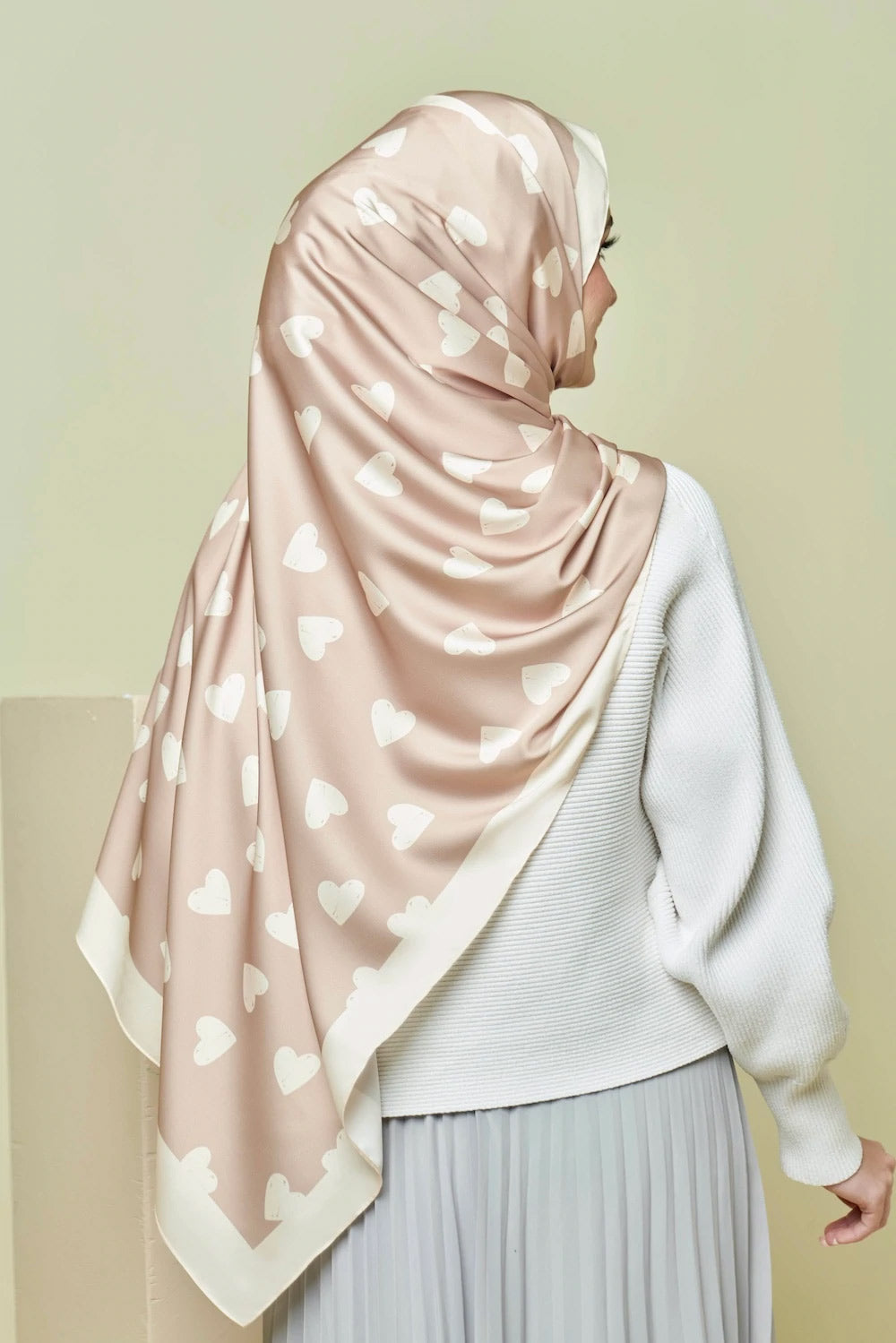 Beige heart patterned hijab on a model  top rated for modest fashion and stylish headscarves