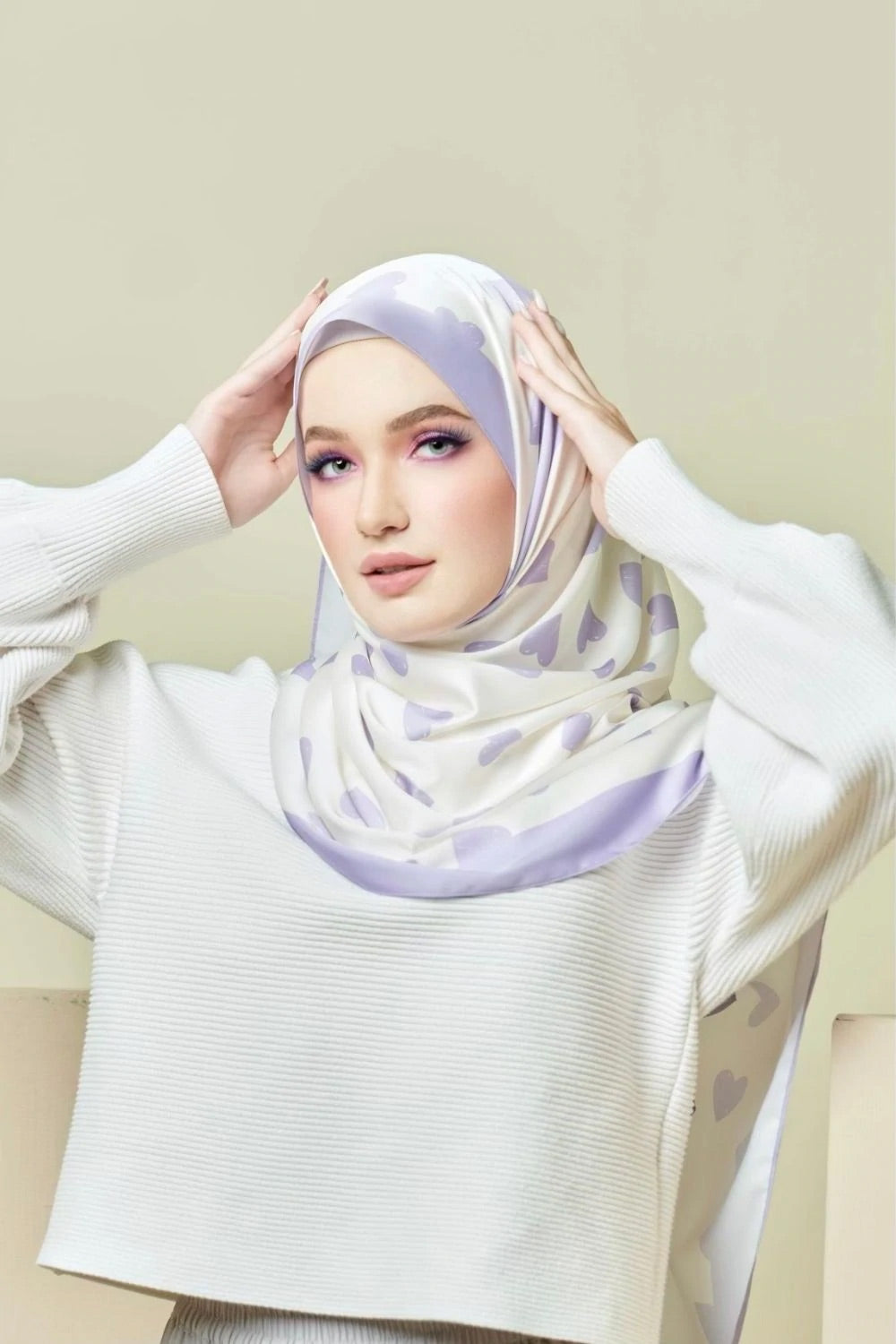 woman wearing a Lavender Love Hijab with a heart pattern, offering a blend of style and modesty, ideal for top fashion and Islamic wear