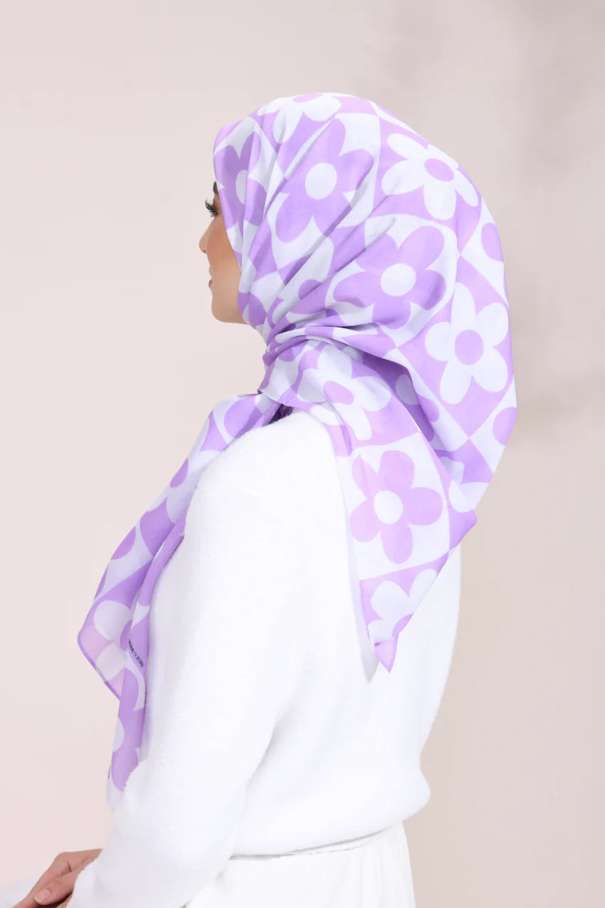 Lilac Blossom Hijab with white floral pattern on a light fabric, perfect for stylish modest fashion enthusiasts