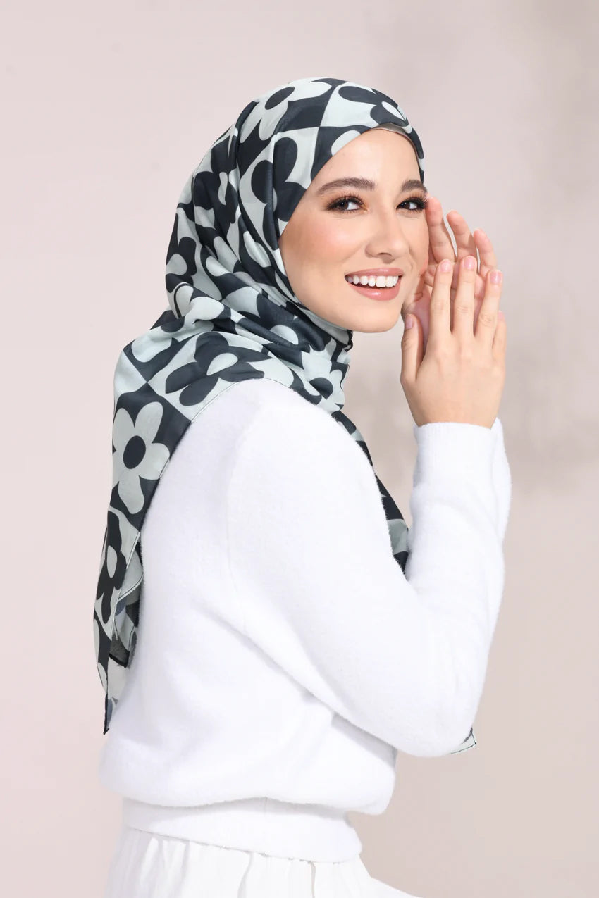 Elegant woman wearing a Monochrome Blossom Hijab with a black and white floral pattern, ideal for a sophisticated and stylish look